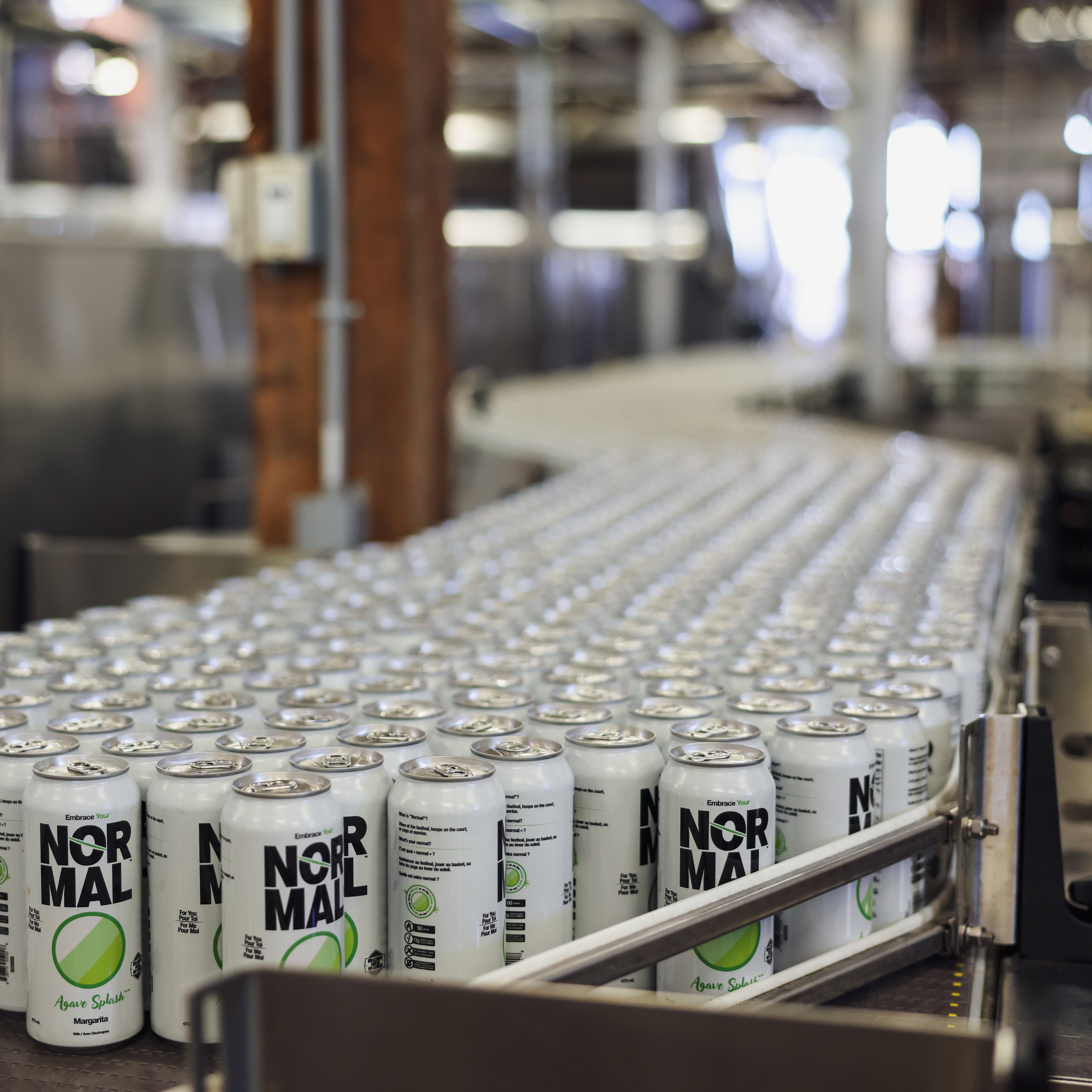 Normal Beverage Ltd., Agave Splash Non-Alcoholic Margarita cocktail on conveyor belt at bottler, ready for boxing. Normal Beverage Ltd., Agave Splash Non-Alcoholic Margarita cocktail on conveyor belt at bottler, ready for boxing.